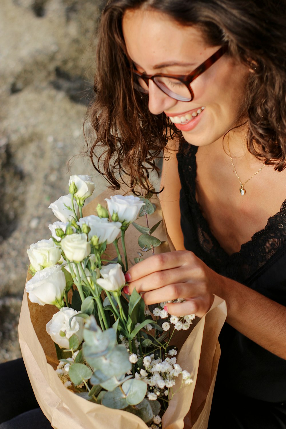 a woman holding a bouquet of white flowers