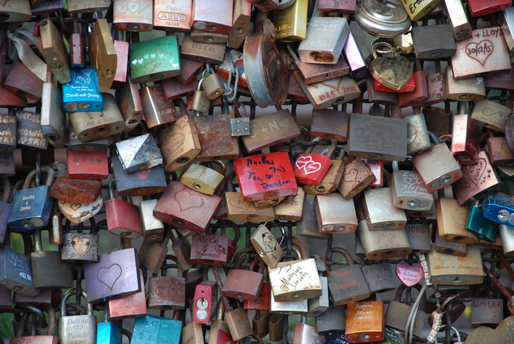a wall covered in lots of padlocks and locks
