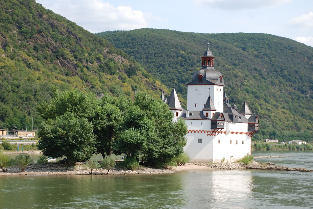 a large white building sitting on top of a river