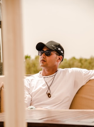 Person relaxing comfortably outdoors in coolfee activewear under bright sunlight.