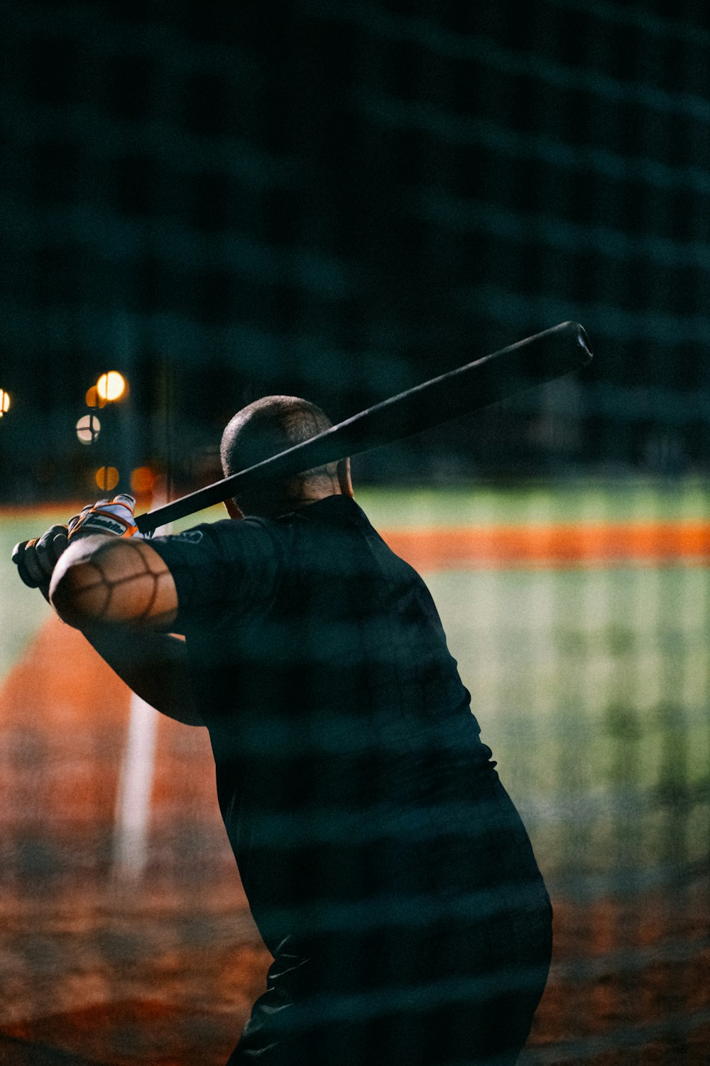 a man holding a baseball bat on top of a field