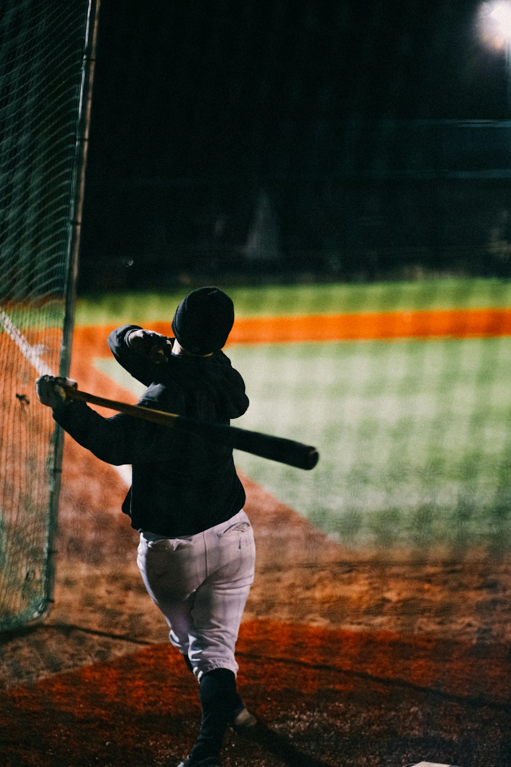 a baseball player swinging a bat at a ball