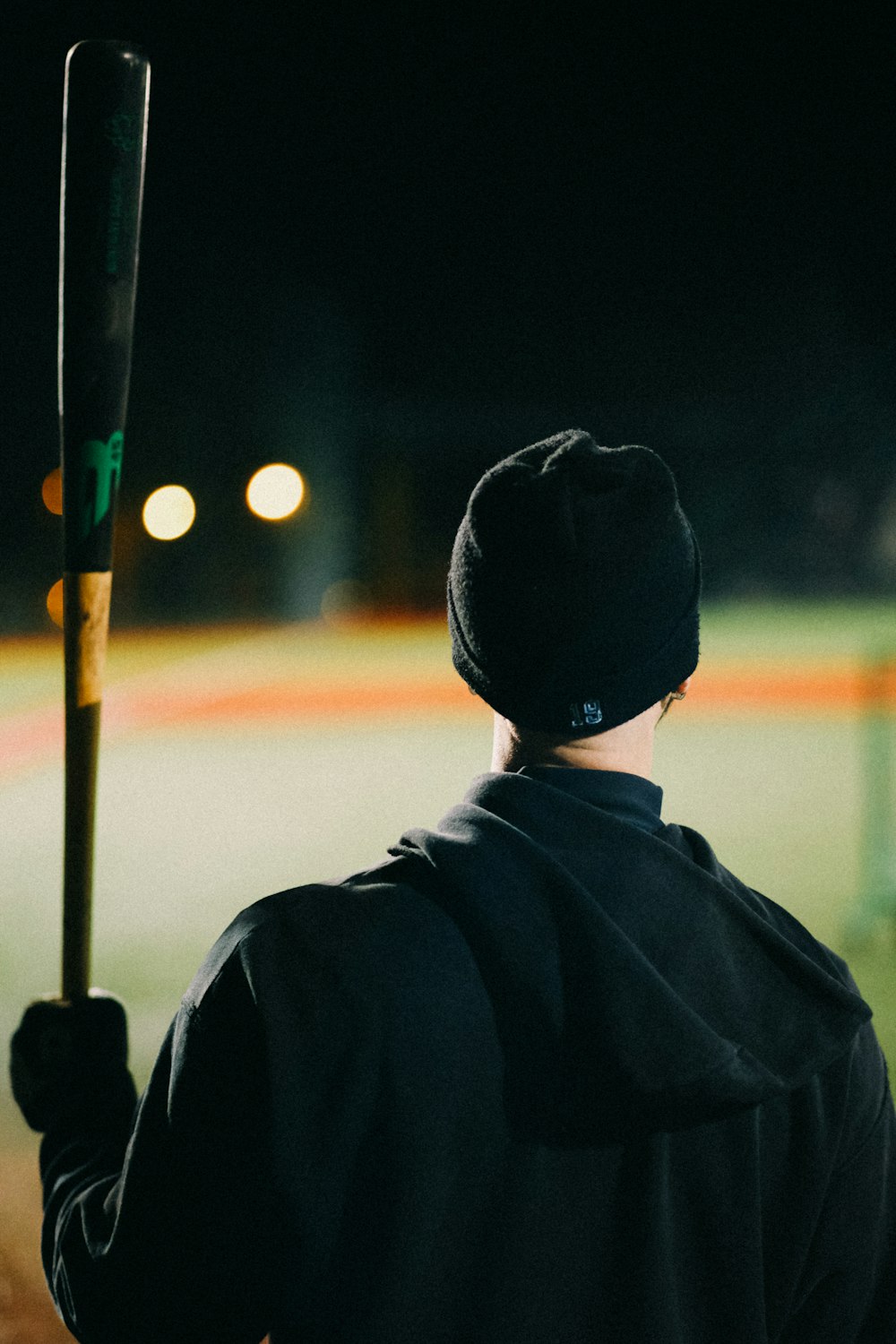 a man holding a baseball bat on a baseball field