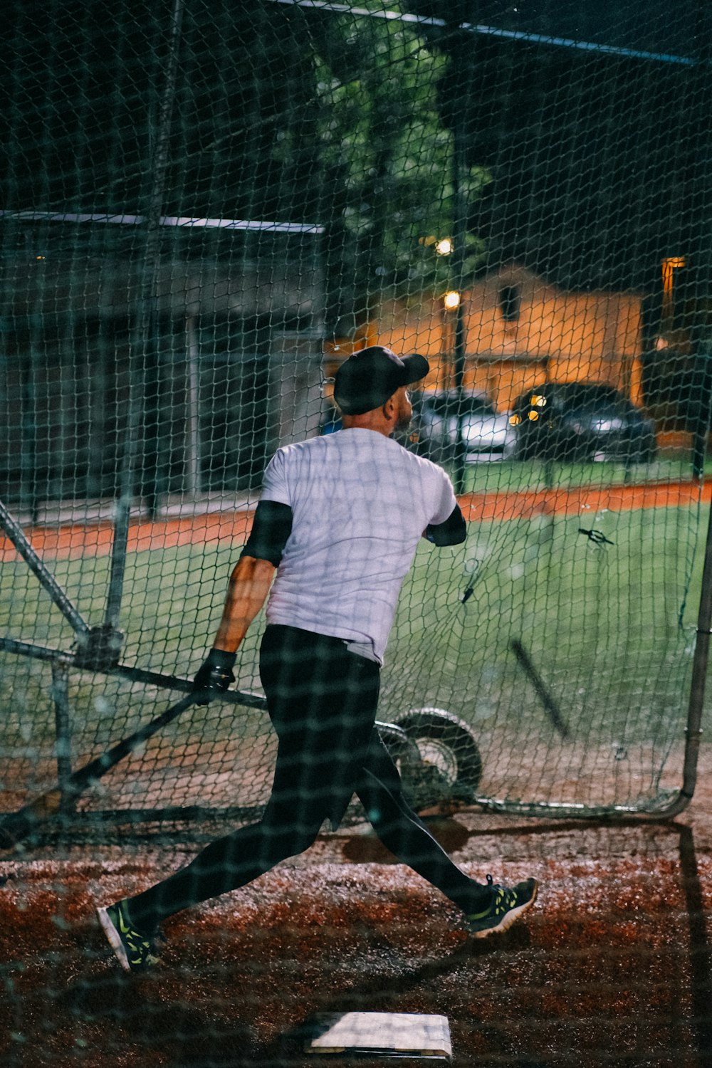 a man swinging a baseball bat at a ball
