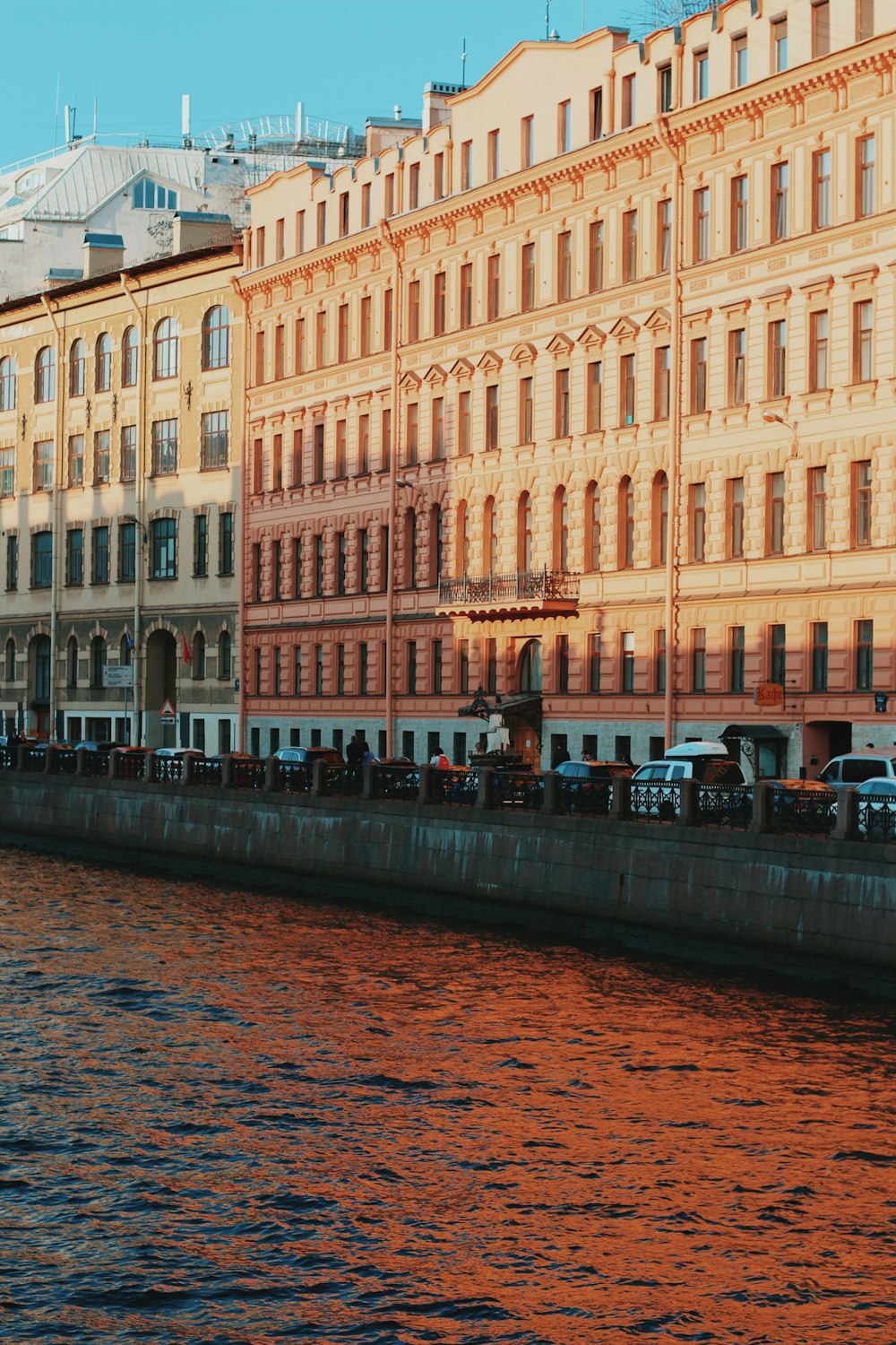 a body of water next to a row of buildings