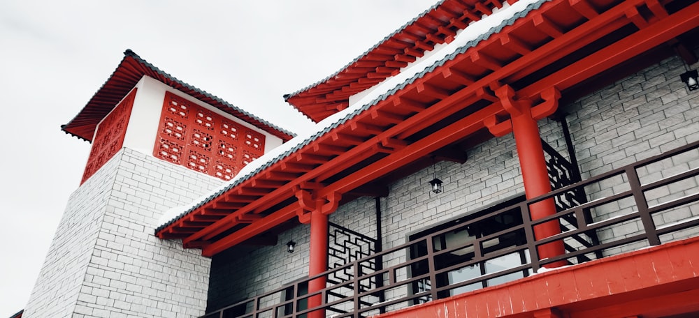 a red and white building with a red roof