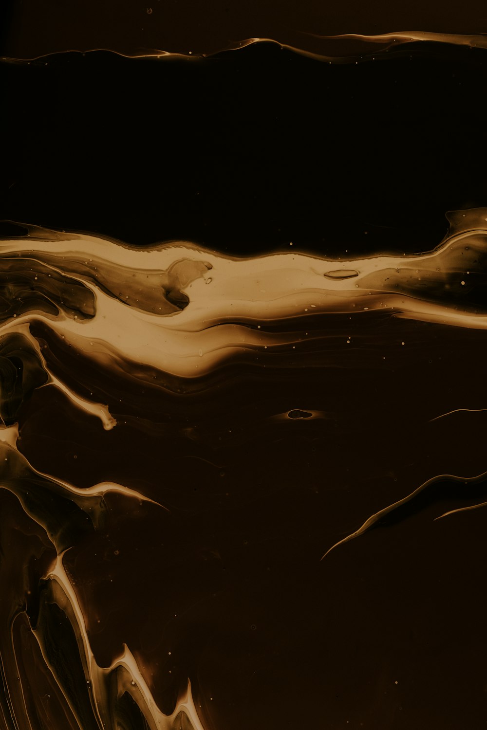 a close up of a brown liquid with a black background