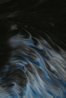 An abstract image of balanced scales of justice against a dark background.