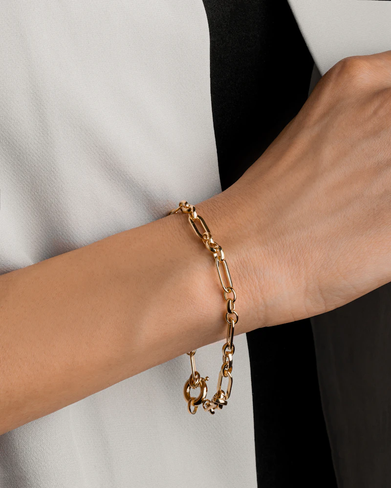 Adult woman's wrist wearing a fine gold link bracelet