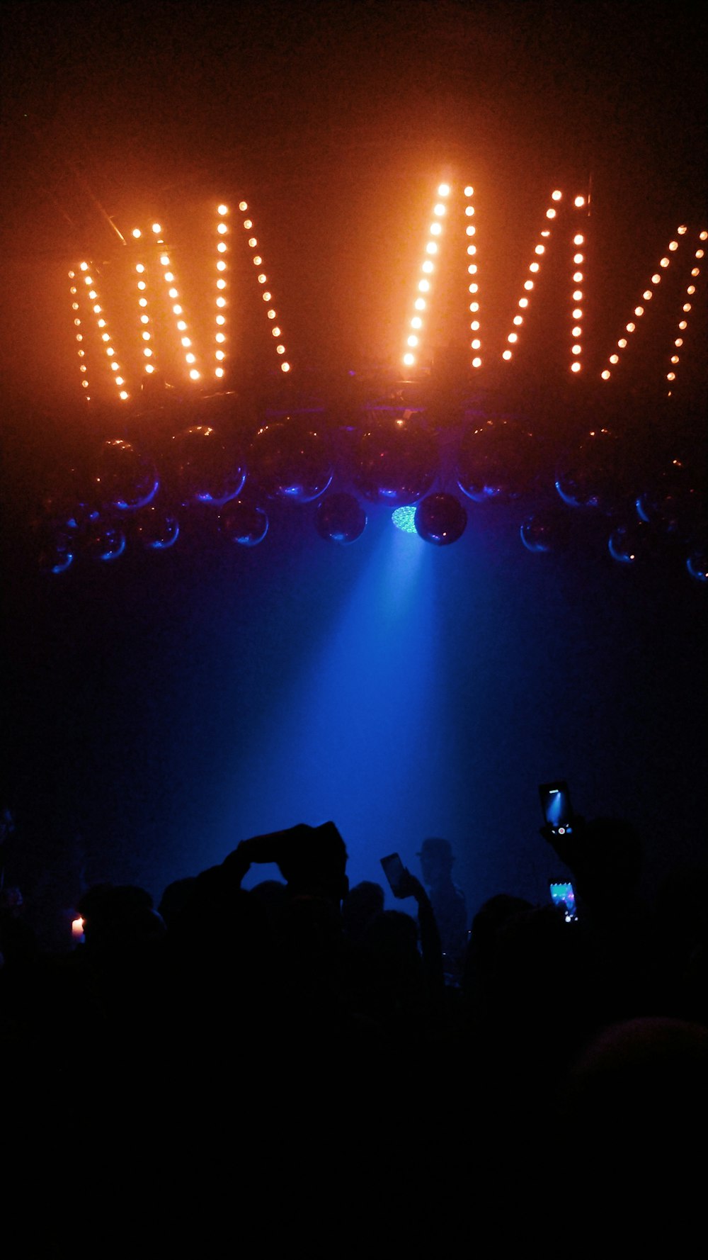 a crowd of people standing around a stage