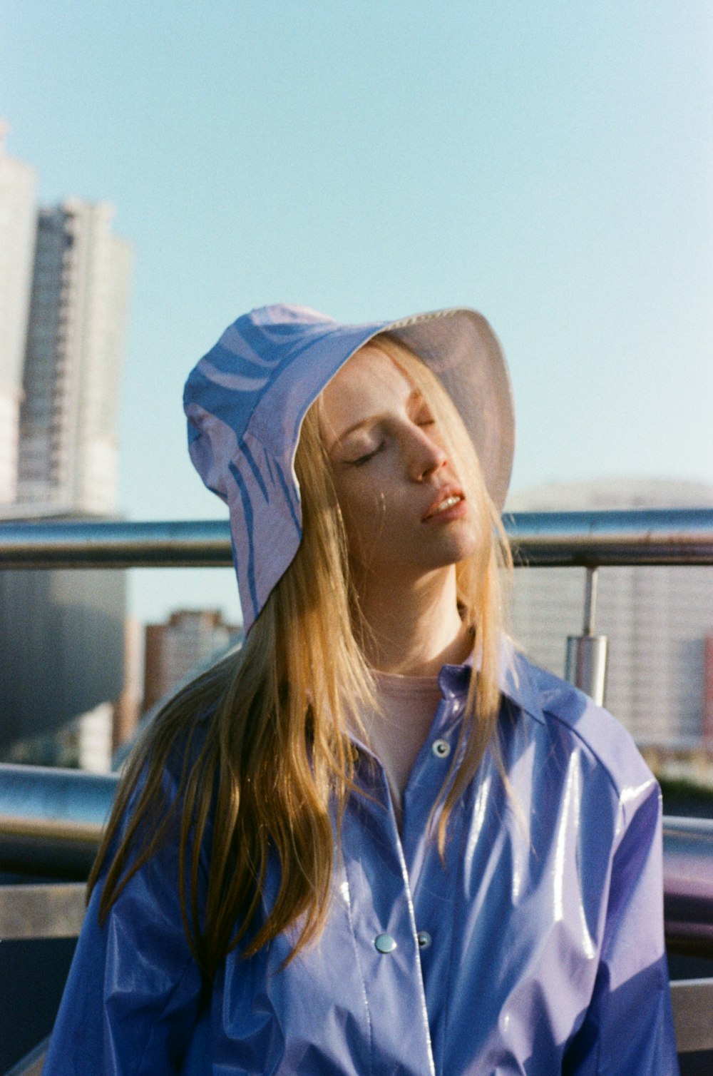 a woman with her eyes closed wearing a hat