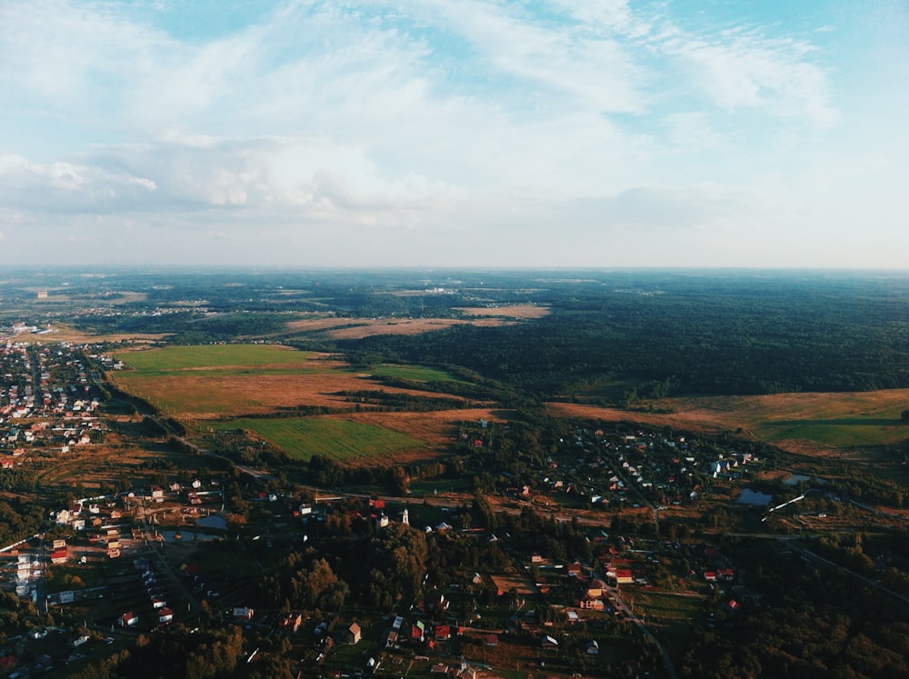 an aerial view of a small town surrounded by trees