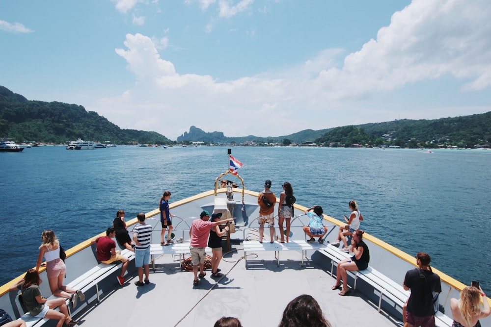 a group of people sitting on a boat in the water