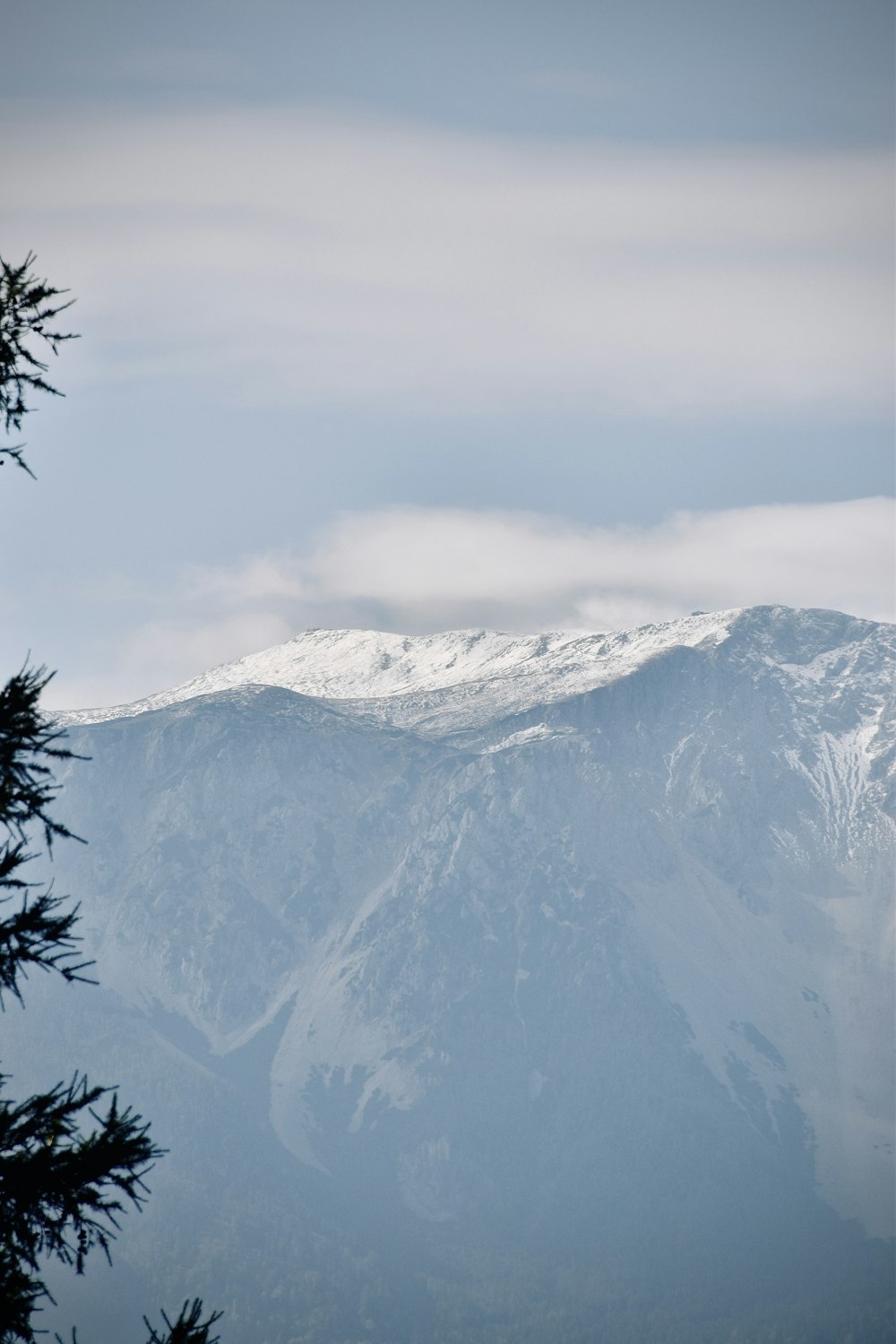 a view of a snowy mountain range from a distance