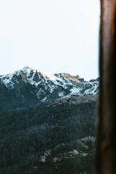 a view of a snowy mountain from a window