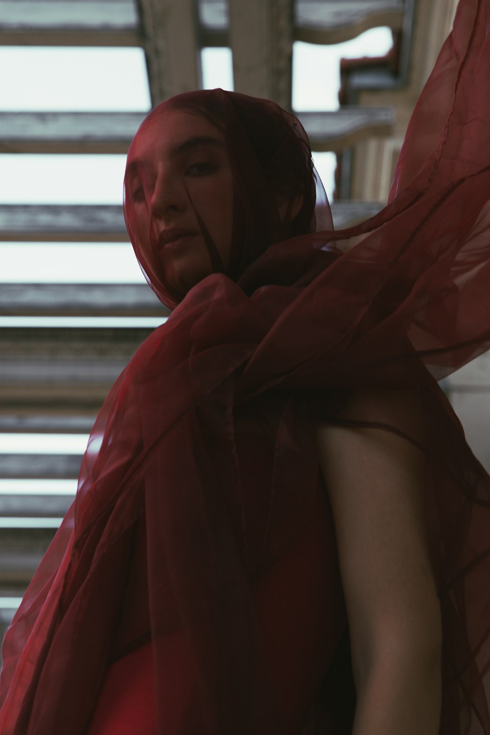 a woman in a red dress with a red scarf around her neck