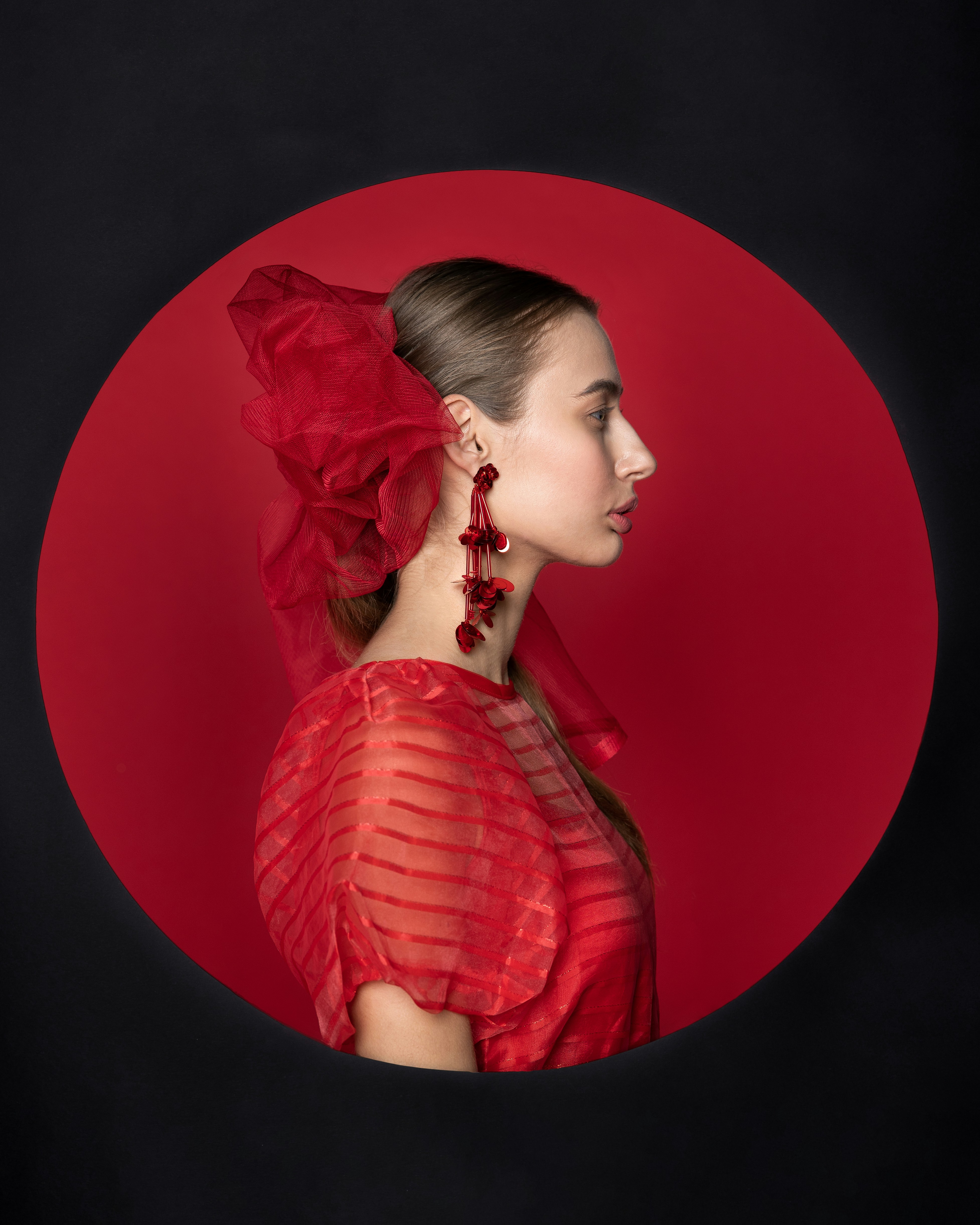 a woman in a red dress with a red flower in her hair