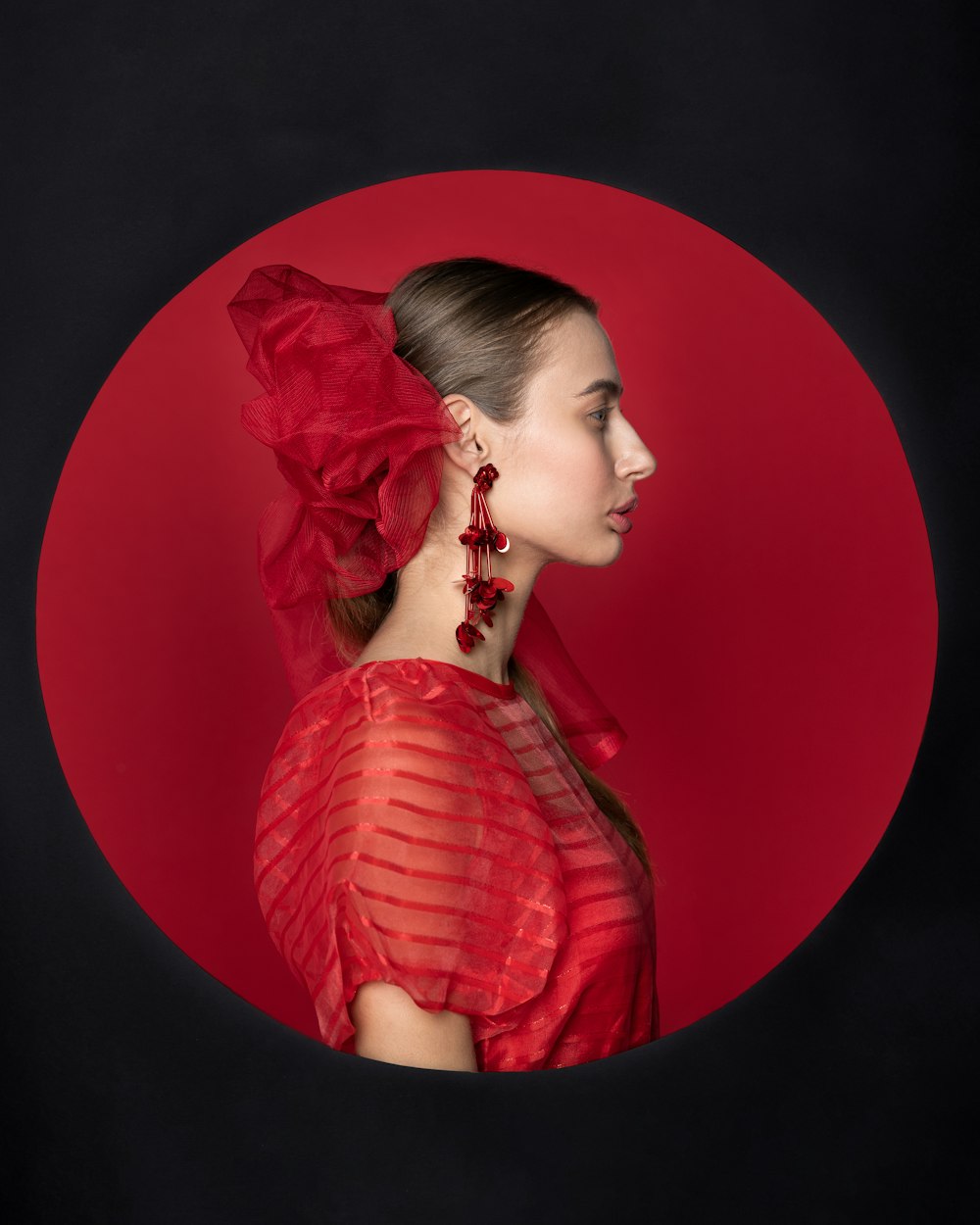 a woman in a red dress with a red flower in her hair