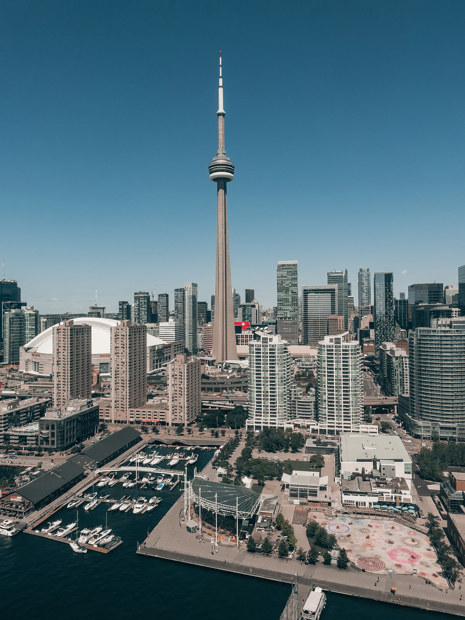 Toronto CN Tower and Rogers Centre rising above the downtown waterfront and marina