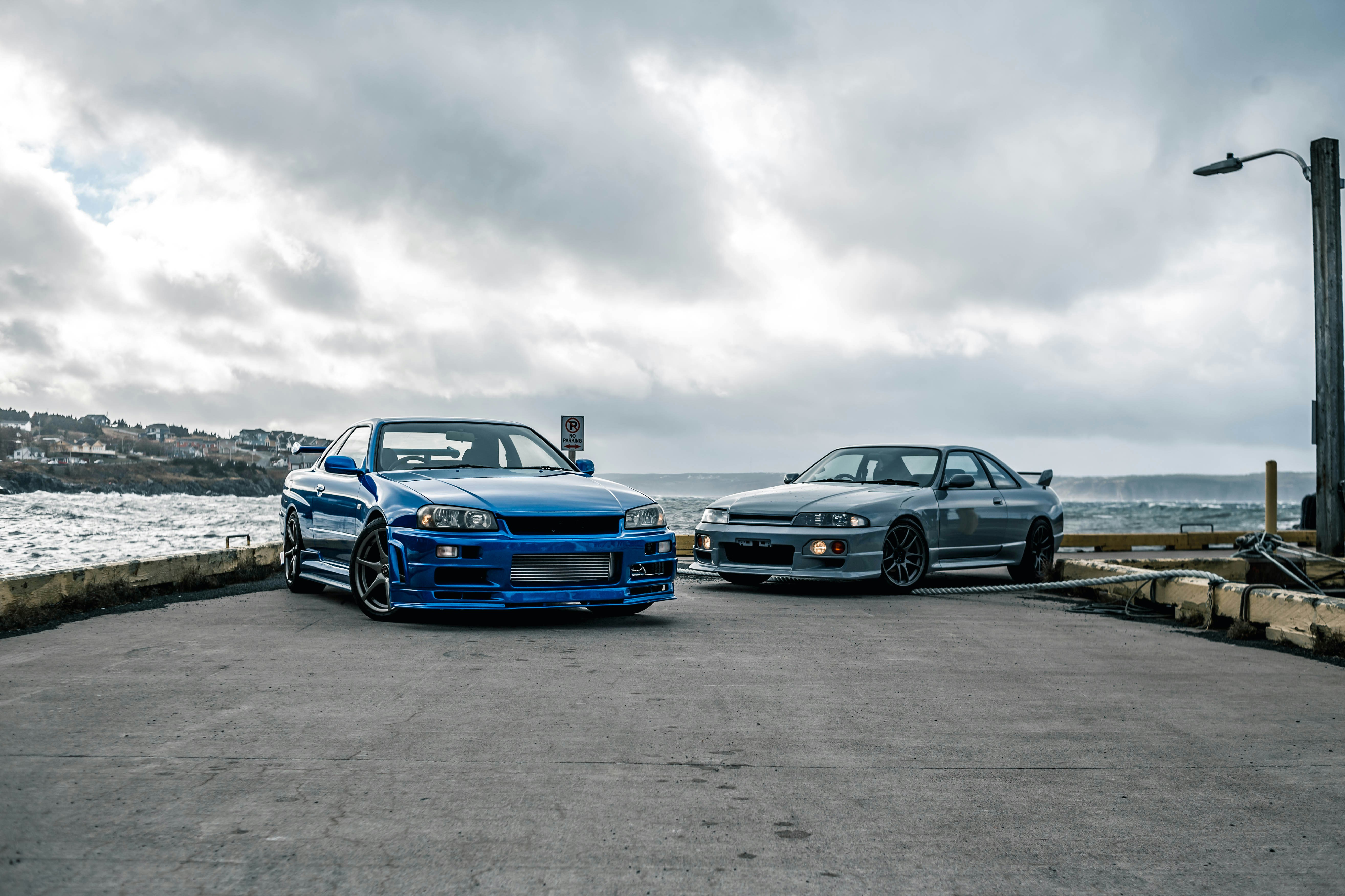 Two cars parked next to each other in a parking lot photo – Free Car ...
