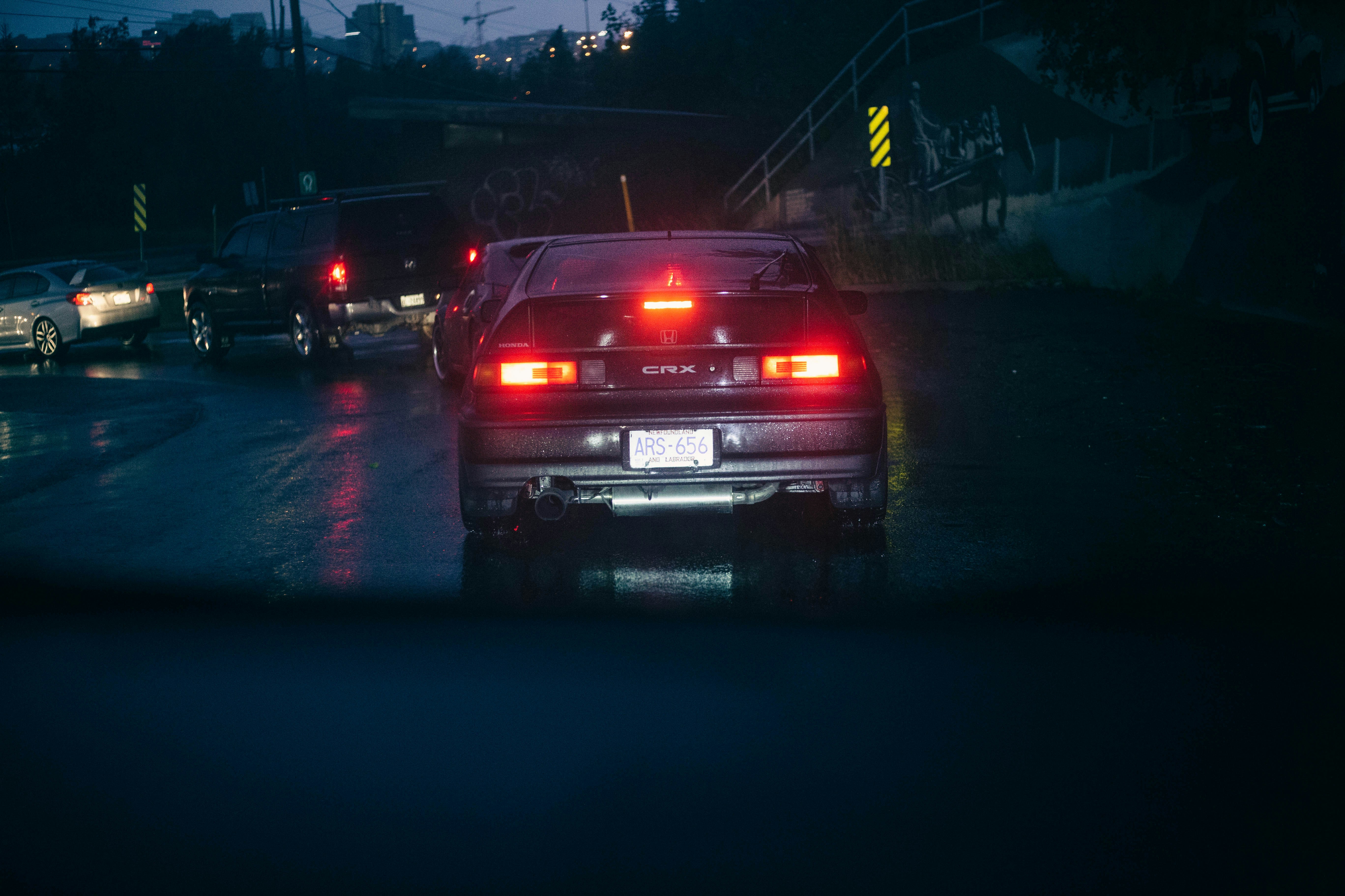 a car stopped at a red light at night
