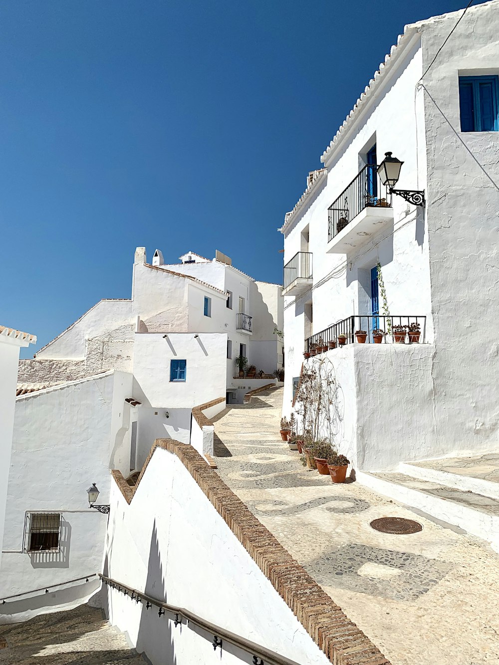 a white building with blue windows and balconies