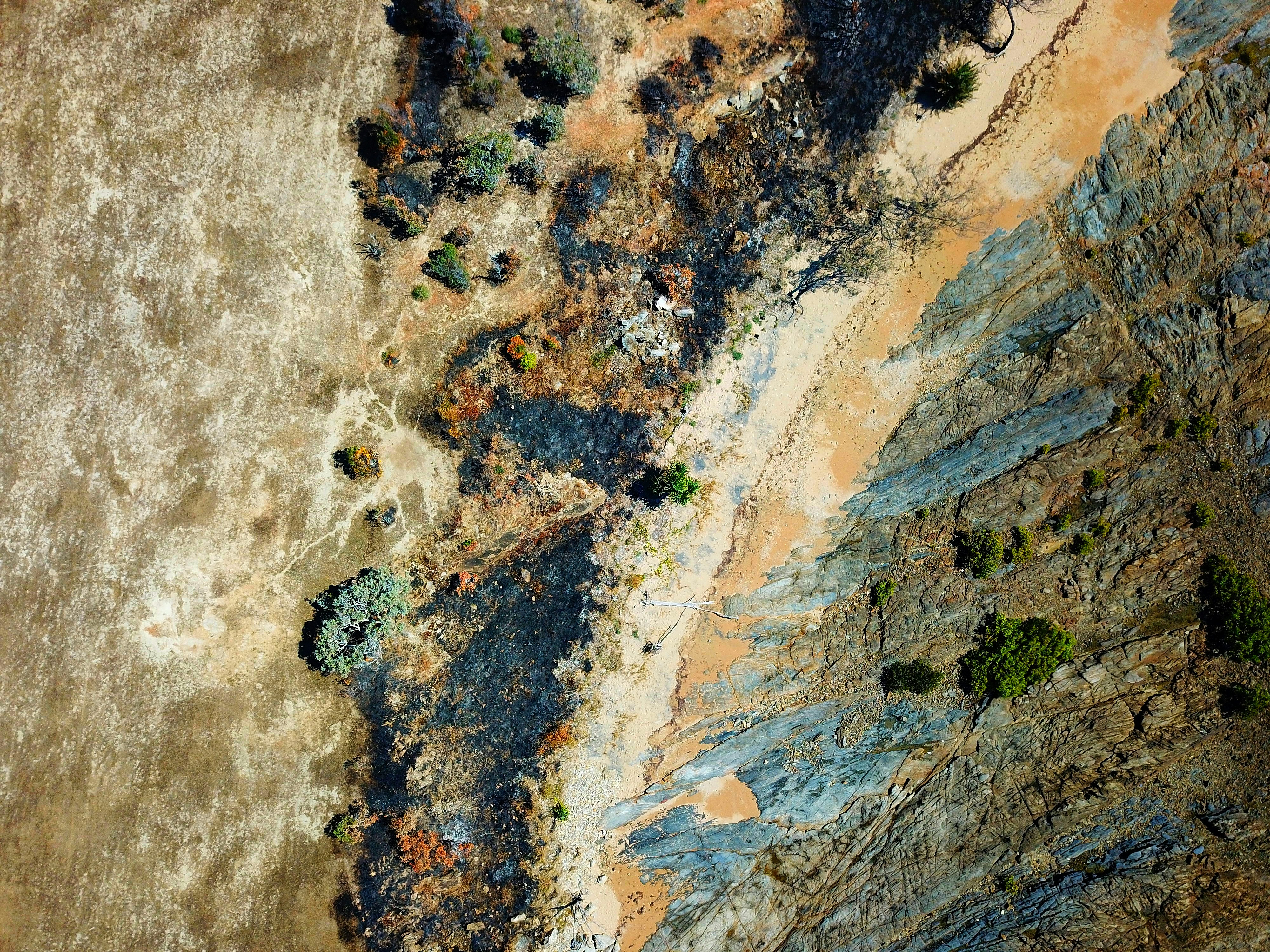 an aerial view of a sandy beach and a body of water