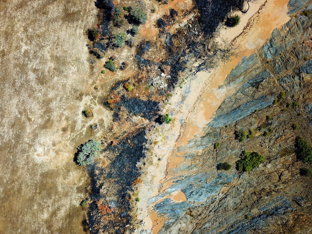 an aerial view of a sandy beach and a body of water