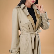 a woman in a trench coat posing for a picture