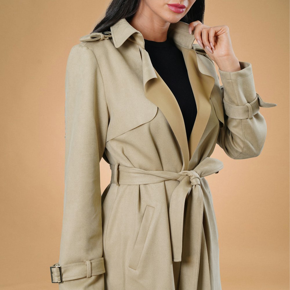 a woman in a trench coat posing for a picture