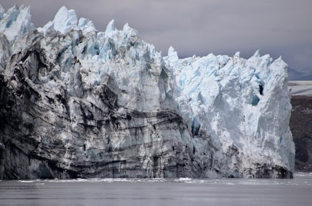 a large iceberg towering over a body of water