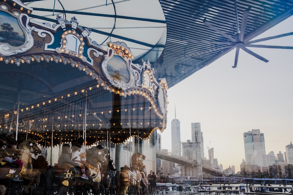 a merry go round in front of a city skyline