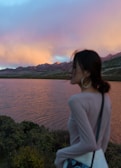 Paras Singh smiling at a lakeside during a peaceful sunset.