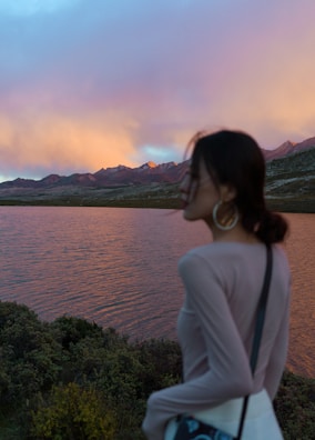 Paras Singh smiling at a lakeside during a peaceful sunset.