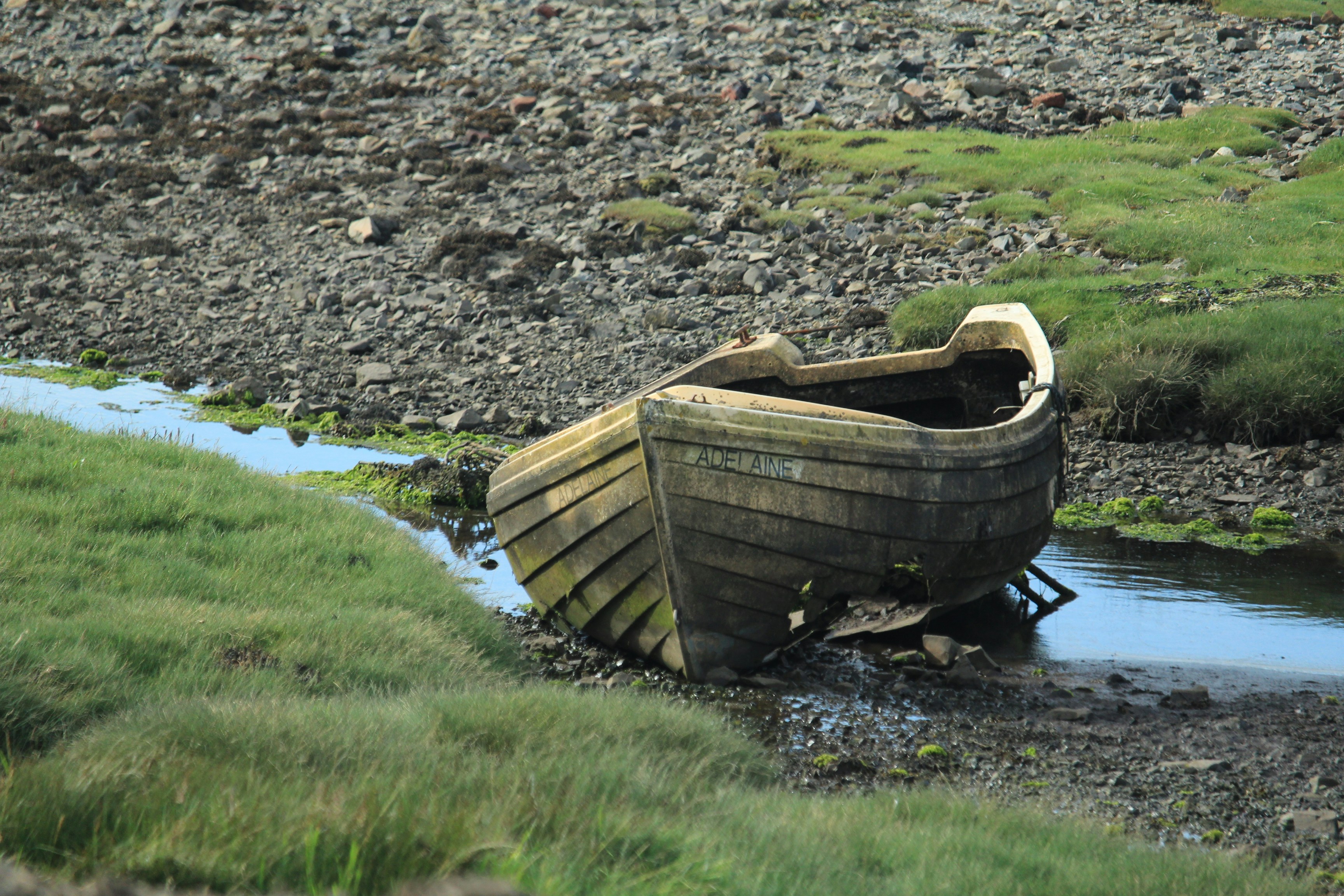 a small boat sitting on top of a river