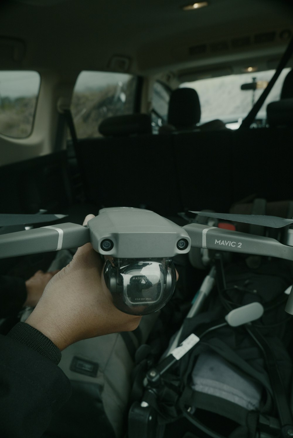 a person holding a camera in a vehicle