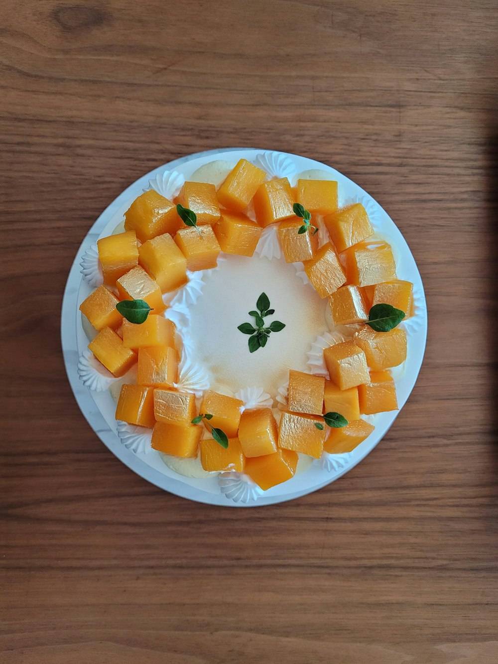 a white plate topped with cut up pieces of fruit