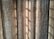 Vertical, textured curtains with light streaming through, creating a pattern of shadows.