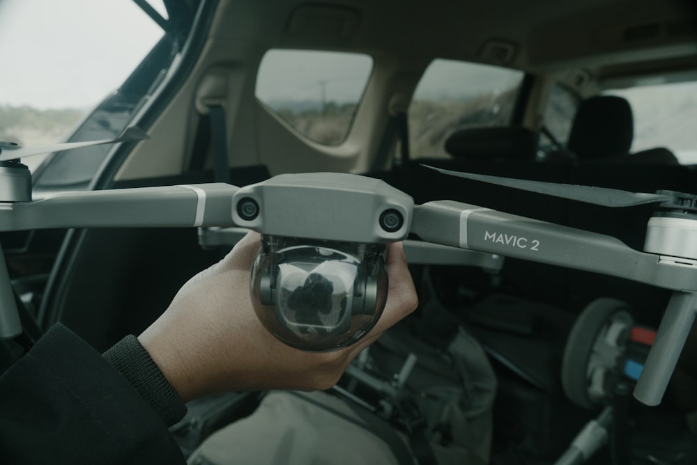 a person holding a camera in a vehicle