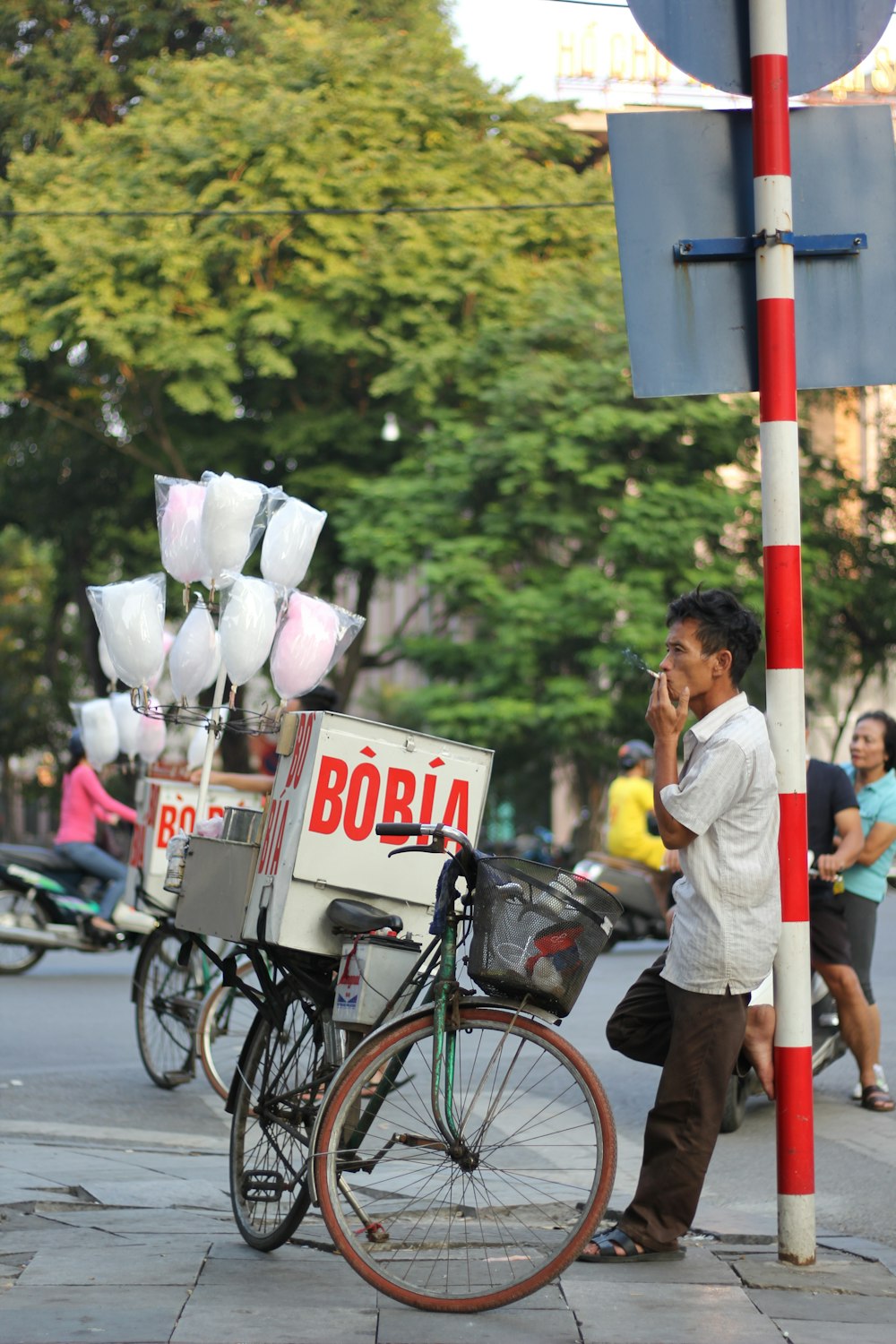 a man talking on a cell phone next to a bike
