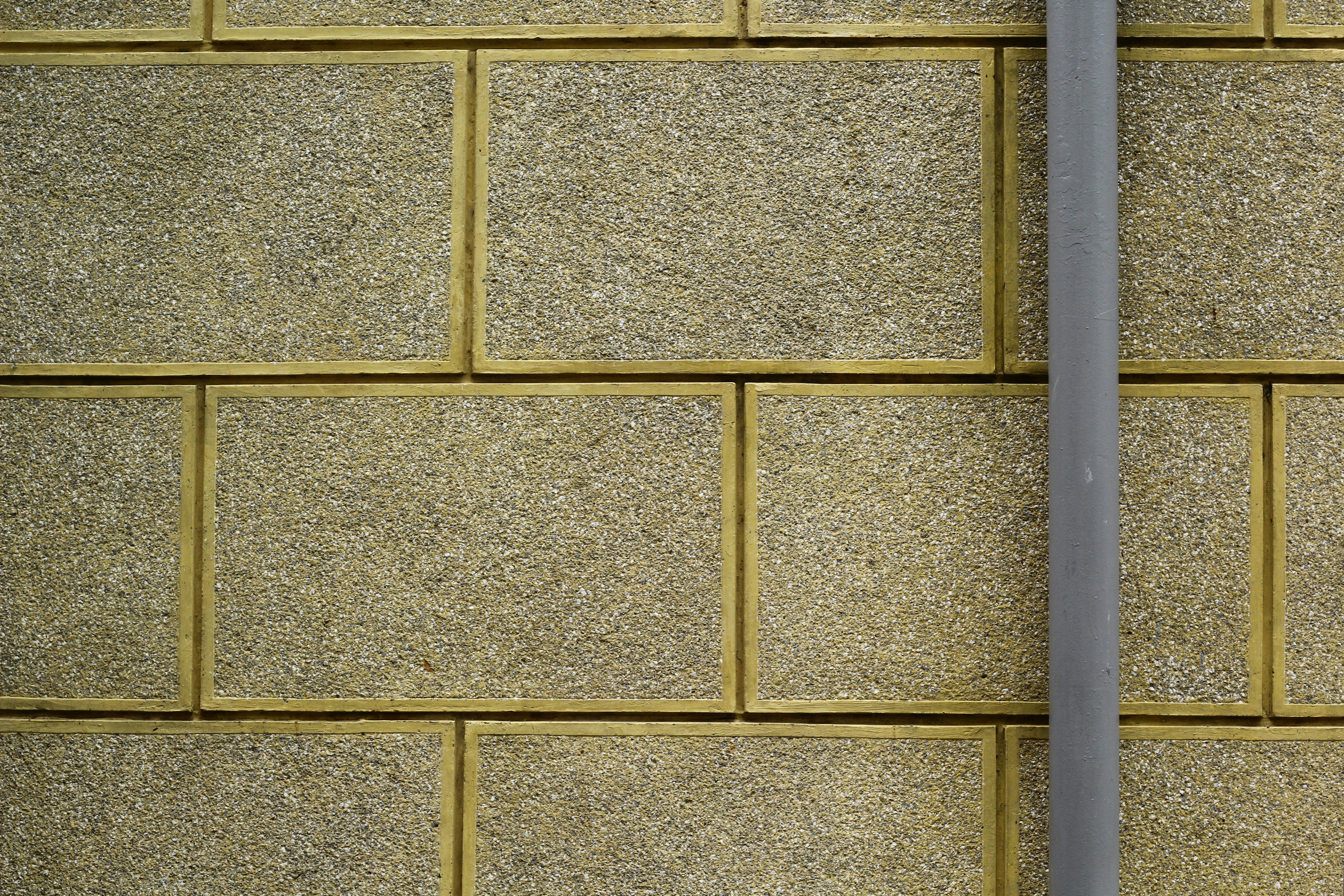 A close up of a street sign on a brick wall photo Free Grey Image on