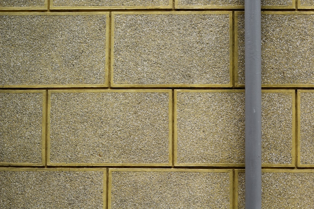 a close up of a street sign on a brick wall