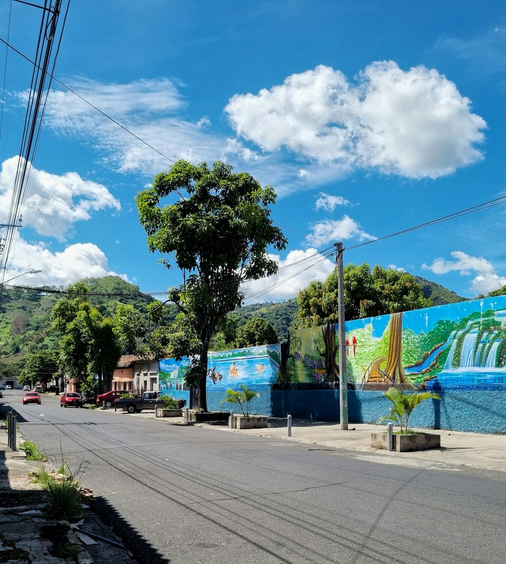 a street with a mural on the side of it