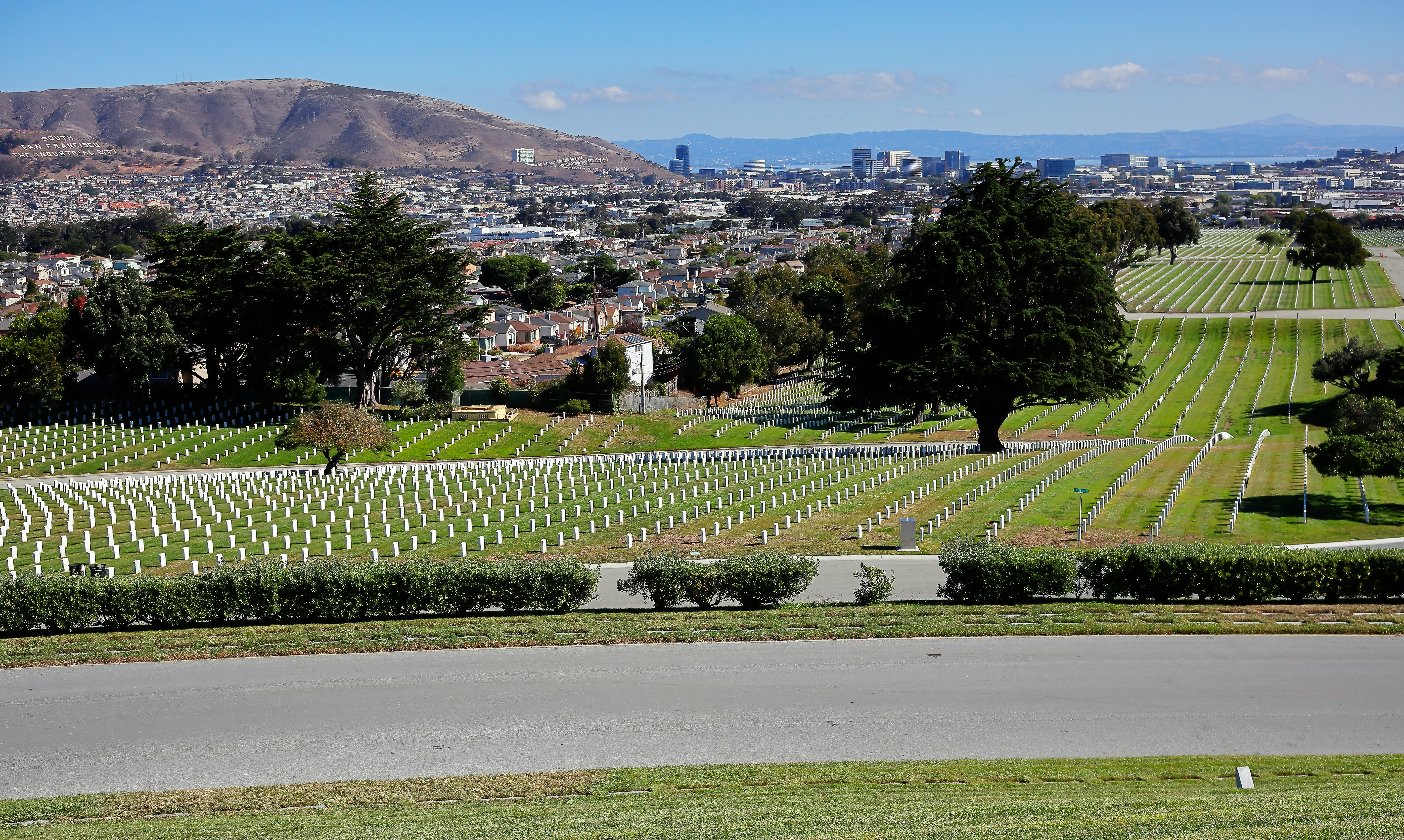 a view of a cemetery with a hill in the background