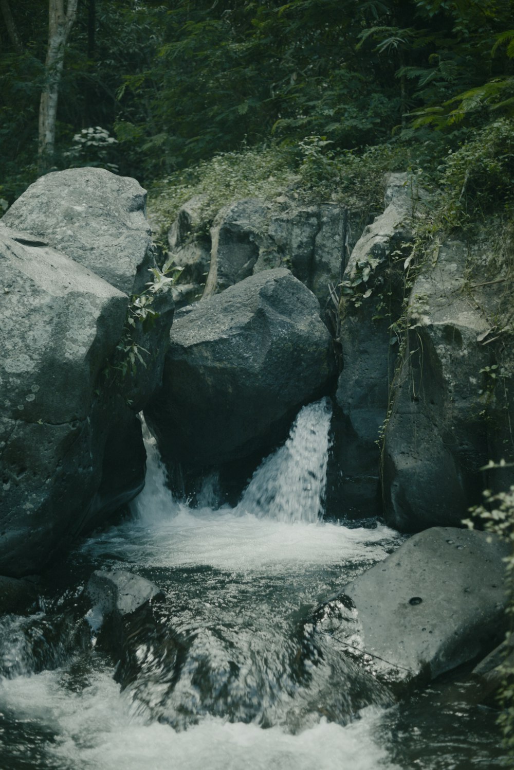 a stream of water running between two large rocks