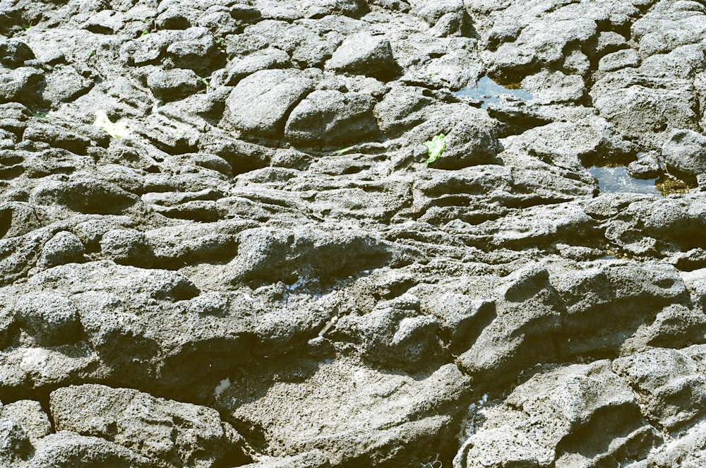 a close up of rocks with water in the middle