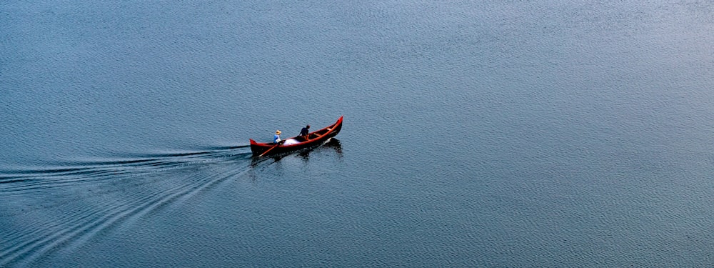 two people in a boat on a large body of water