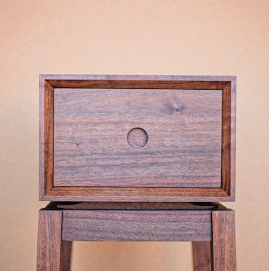 a wooden table with a drawer on top of it