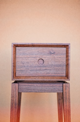 a wooden table with a drawer on top of it