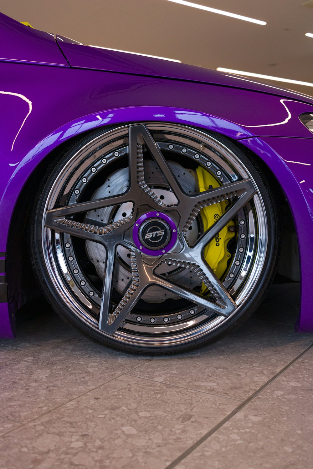 a purple sports car parked in a garage